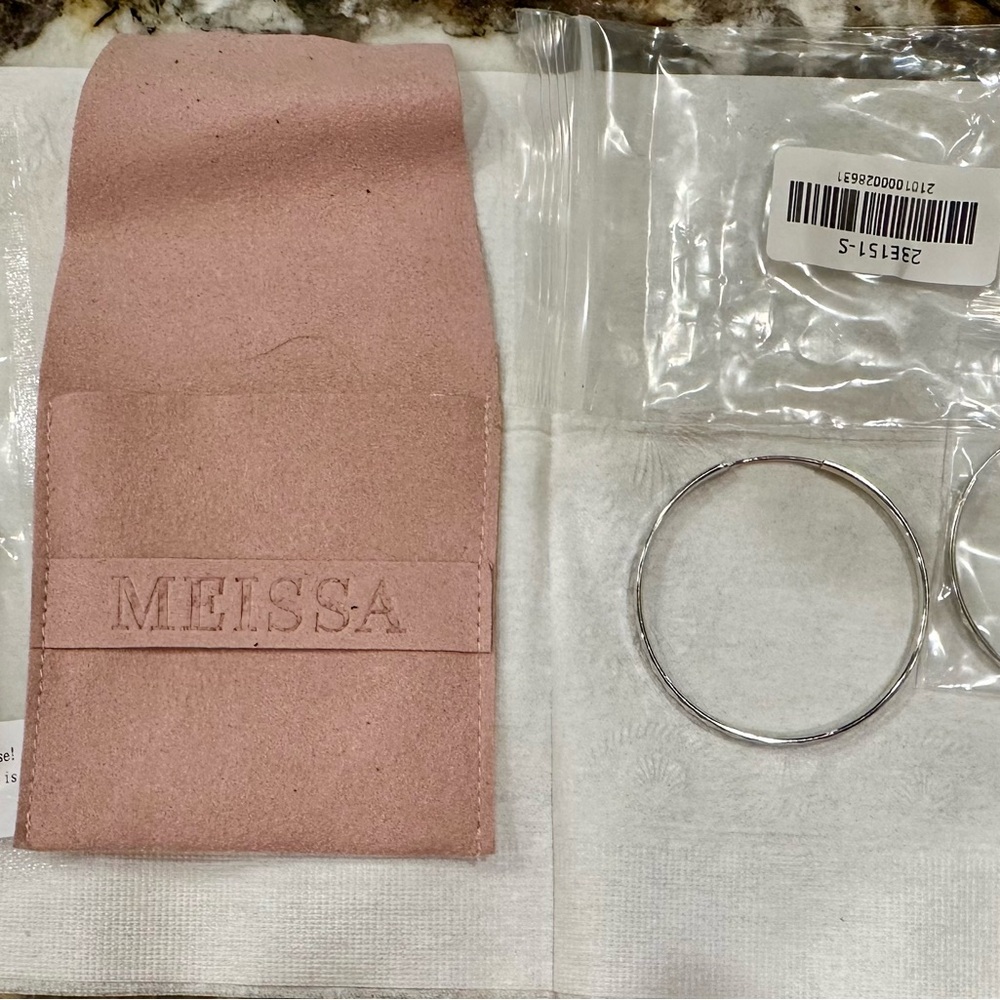 Silver hoop pierced earrings new. Never worn. With storage bag